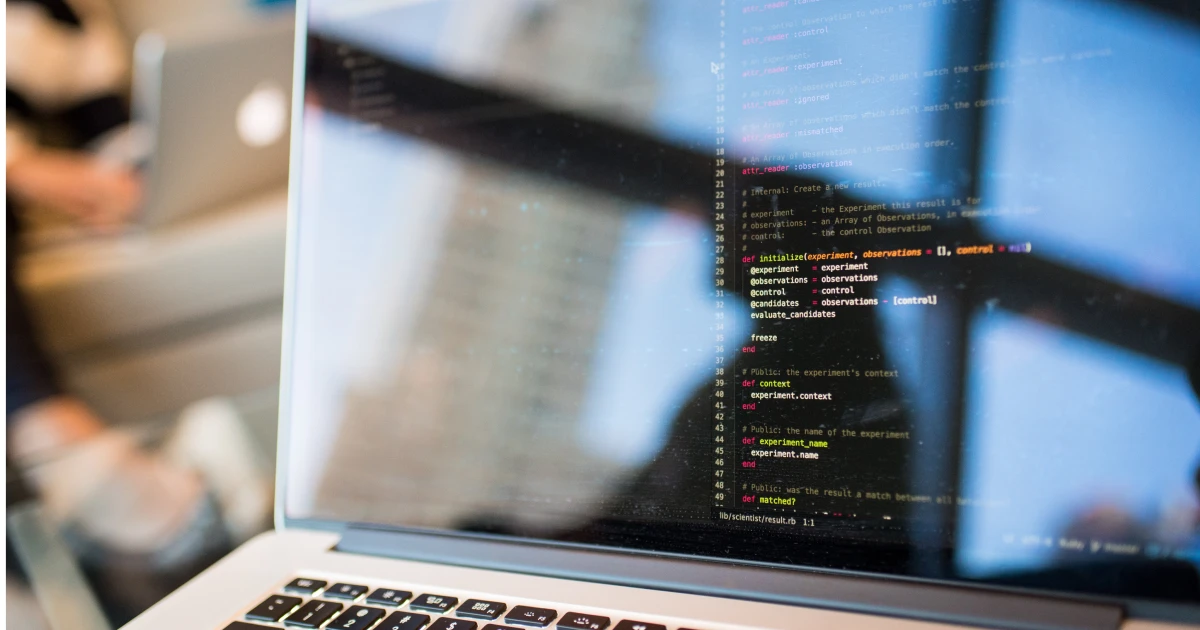 Open laptop displaying code.