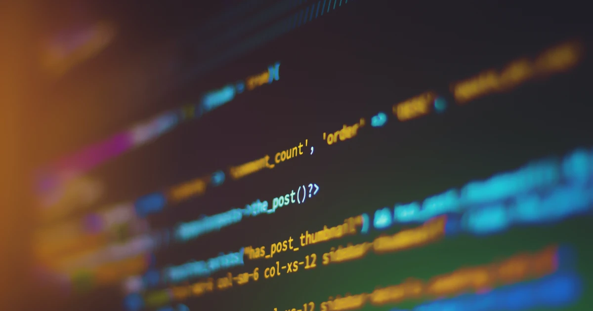 Blurred edge photo of software code on a black screen