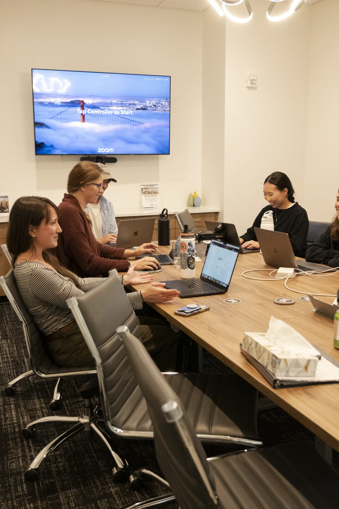 People discussing work around a conference-room table